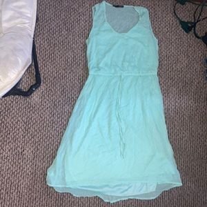 A sleeveless knee length gold dotted dress. Unworn. Great condition.